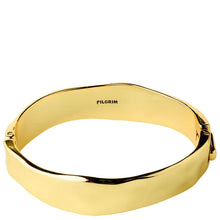 A polished gold bangle bracelet with an irregular, wavy edge, featuring the brand name 'PILGRIM' engraved inside, shown on a plain white background.