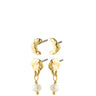 A pair of gold-toned dangle earrings with organic, textured crescent-shaped tops and hanging white pearl beads, shown on a plain white background.
