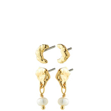 A pair of gold-toned dangle earrings with organic, textured crescent-shaped tops and hanging white pearl beads, shown on a plain white background.