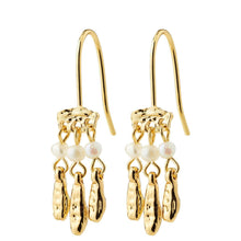 A pair of gold dangle earrings with small white pearl beads and hammered gold charms, shown on a plain white background.