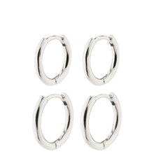 Four pairs of silver hoop earrings on a white background