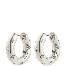 Pair of silver hoop earrings with star designs on a white background