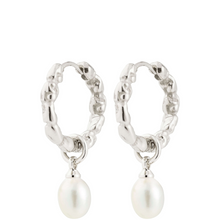 Silver hoop earrings with pearl drops on a white background