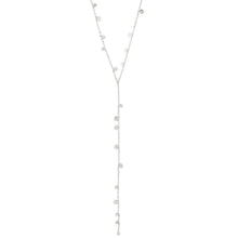 A delicate silver Y-necklace featuring multiple small, flat circular disc charms in varying sizes along the chain, displayed against a solid white background.