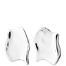 A pair of abstract, fluid-shaped silver stud earrings with a polished, reflective metallic finish, shown against a solid white background.