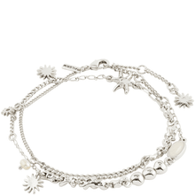 Silver bracelet with various charms on a white background