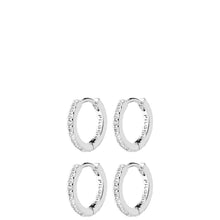 Four silver huggie hoop earrings, each adorned with a row of clear pavé-set cubic zirconia stones, arranged in a 2x2 grid on a solid white background. The brand name 'PILATES' is engraved on the inside of the hoops.