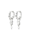 A pair of silver huggie hoop earrings with dangling charms, including a small heart, a textured animal silhouette, and a tiny pearl bead, shown on a plain white background.