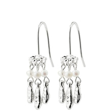 A pair of silver drop earrings with textured metal charms, small white pearl beads, and three dangling silver teardrop charms on a plain white background.