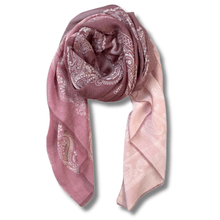 Pink scarf with white paisley patterns on a white background