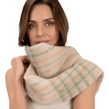 Woman wearing a plaid scarf on a white background