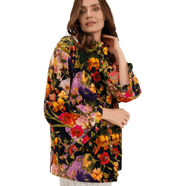 Woman wearing a colorful floral dress on a white background