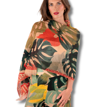 Woman wearing a colorful scarf with leaf patterns on a white background