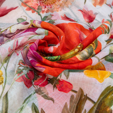 Close-up of a floral fabric with a prominent red rose.