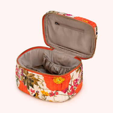 Floral-patterned makeup bag with orange accents on a white background