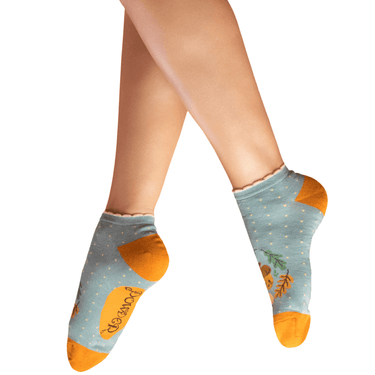 Light blue socks with orange accents worn by a person on a white background