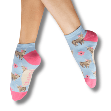 Light blue socks with animal pattern worn by a person on a white background