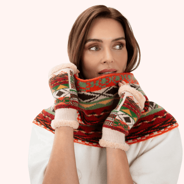Woman wearing a colorful patterned scarf and gloves on a white background