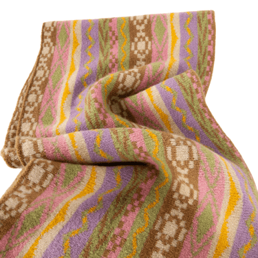 Colorful patterned fabric with a mix of pink, purple, green, and yellow on a white background