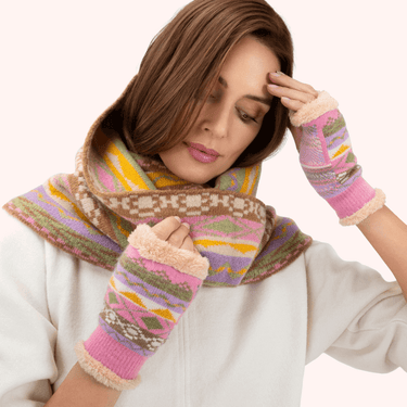 Woman wearing a colorful scarf and matching gloves on a white background