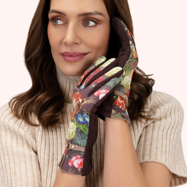 Woman wearing a floral patterned glove on a plain background
