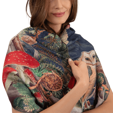 Woman wearing a colorful scarf with nature-themed design