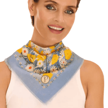 Woman wearing a floral scarf with a blue border on a white background