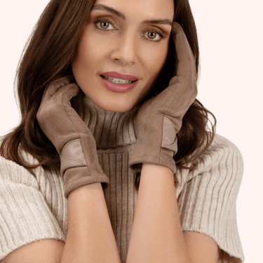 Woman wearing brown gloves and a scarf on a beige background