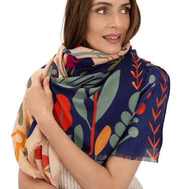 Woman wearing a colorful floral scarf on a white background