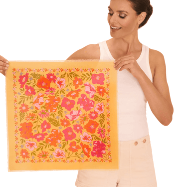 Woman holding a floral towel with a white background
