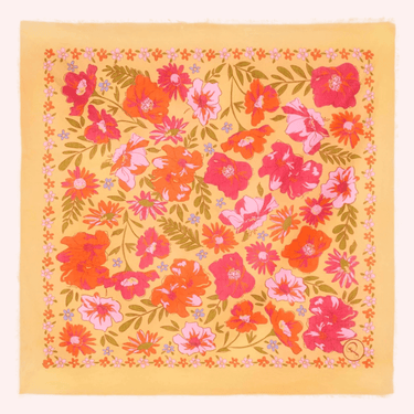 Floral patterned fabric with pink, orange, and green flowers on a yellow background