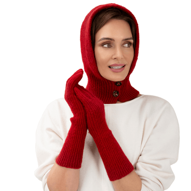 Woman wearing a red knitted hood and gloves on a white background