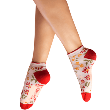 Floral-patterned socks with red toes and cuffs on a white background