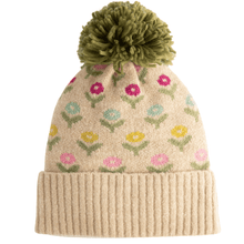 Knitted beanie with floral pattern and green pom-pom on a white background