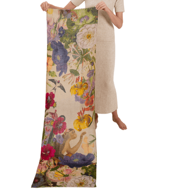 Person holding a long, floral-patterned fabric with a white background