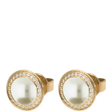 Gold rings with pearl-like centers and diamond-studded bezels on a white background