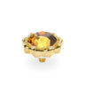 A gold-plated metal knob with a scalloped flower-like border surrounding a faceted amber-orange crystal, shown on a clean white background.