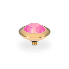 Decorative pink gem and gold base on a white background