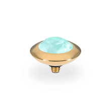 Decorative gold base and teal gem for a ring on a white background