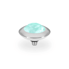 Light green gemstone in a silver setting on a white background