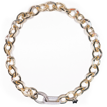 Gold chain bracelet with a star charm on a white background