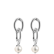 Silver earrings with pearl drops on a white background