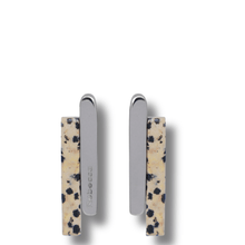 Two earrings with a spotted pattern on a white background