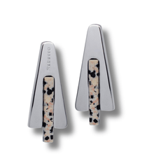Pair of silver earrings with speckled design on a white background