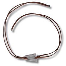 Brown leather cord necklace with silver pendant on a white background