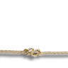 A close-up of a gold chain bracelet featuring a knotted central charm, shown against a plain white background with a soft shadow.