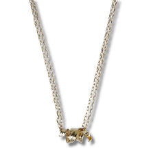 A delicate double-strand chain necklace with a small, textured gold elephant pendant, shown against a plain white background.