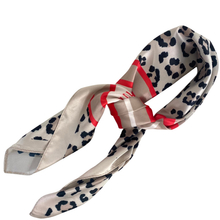 Leopard print scarf with a red ribbon on a white background