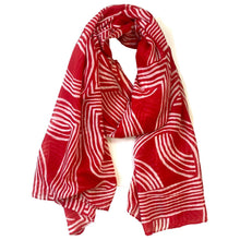 Red scarf with white geometric pattern on a white background
