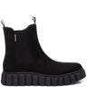 A black Chelsea-style ankle boot with a thick lug sole, shown in a side profile on a white background. A small 'Furmash' brand tag is visible on the side elastic panel.
